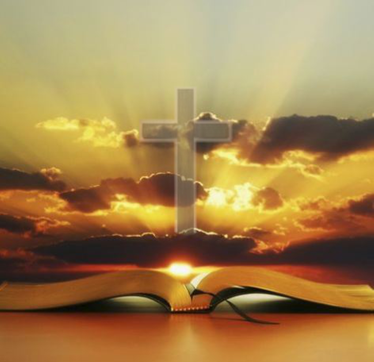 Cross over Bible at sunset
